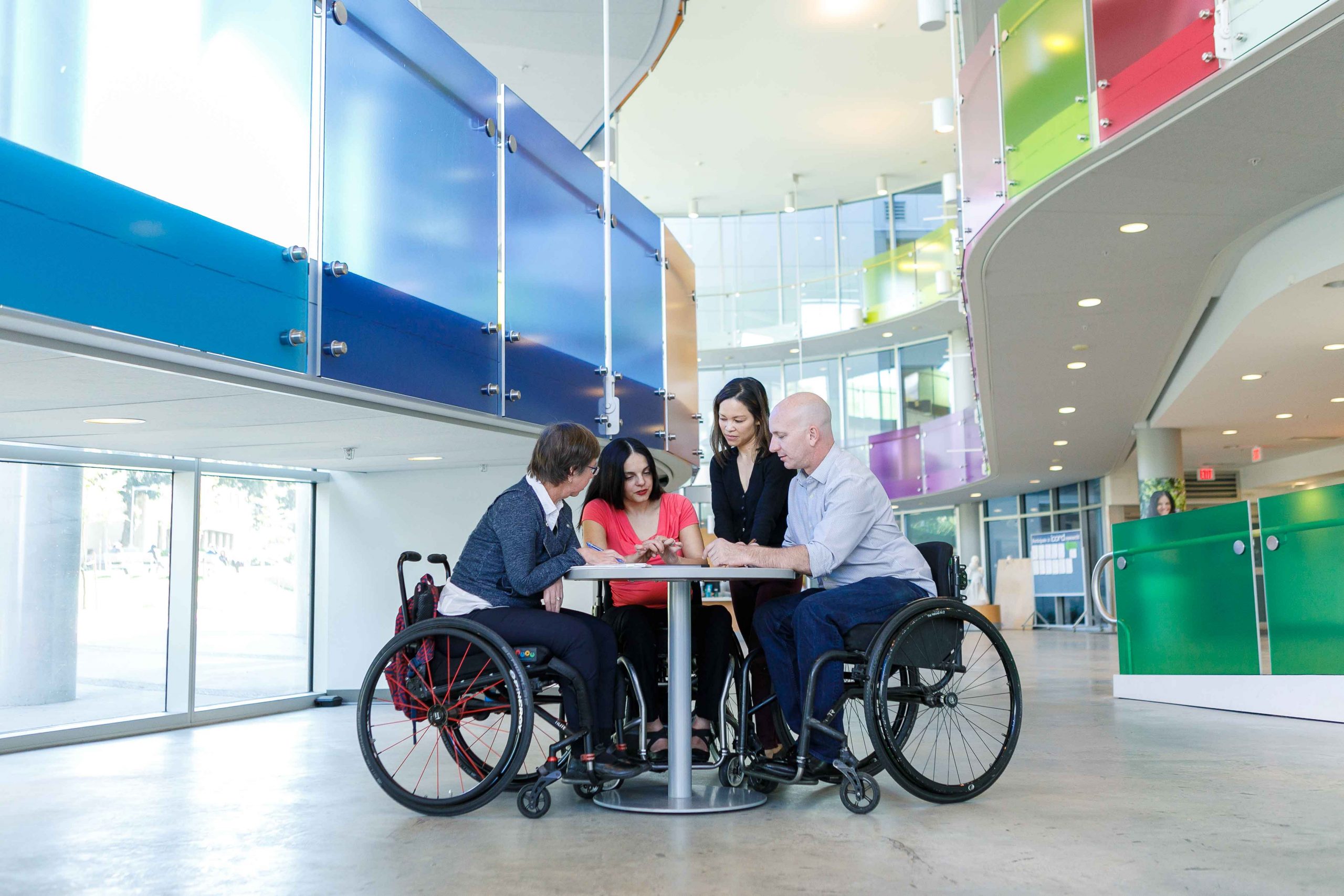 Individuals with spinal cord injury sitting at a table at the Blusson Spinal Cord Centre, Vancouver